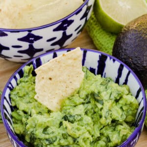 bowl of Easy Homemade Guacamole with a chip in it