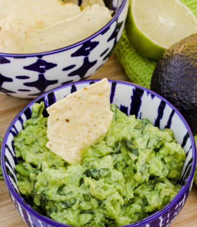 bowl of Easy Homemade Guacamole with a chip in it