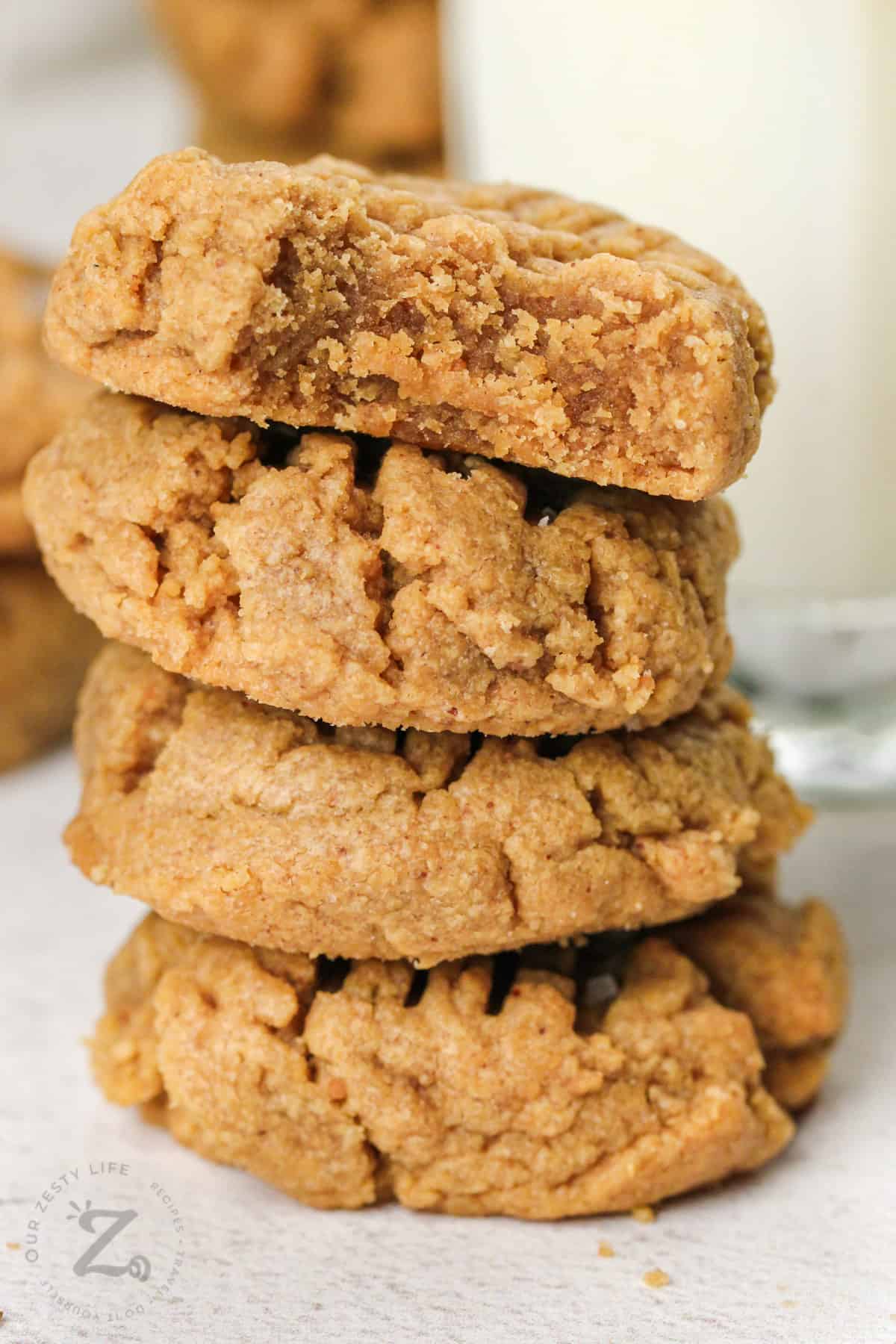 pile of Flourless Peanut Butter Cookies with a bite taken out of one