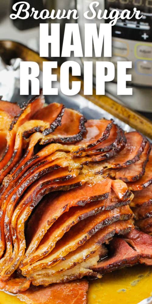 cooked Instant Pot Ham with Brown Sugar Glaze on a baking sheet with writing