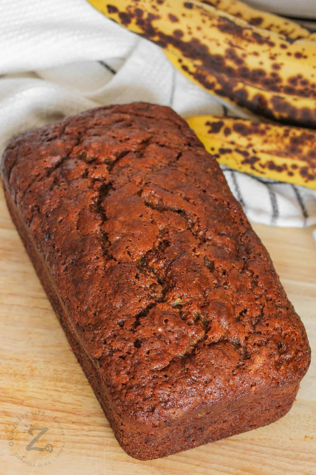 loaf of Nut-Free Banana Bread with bananas beside it