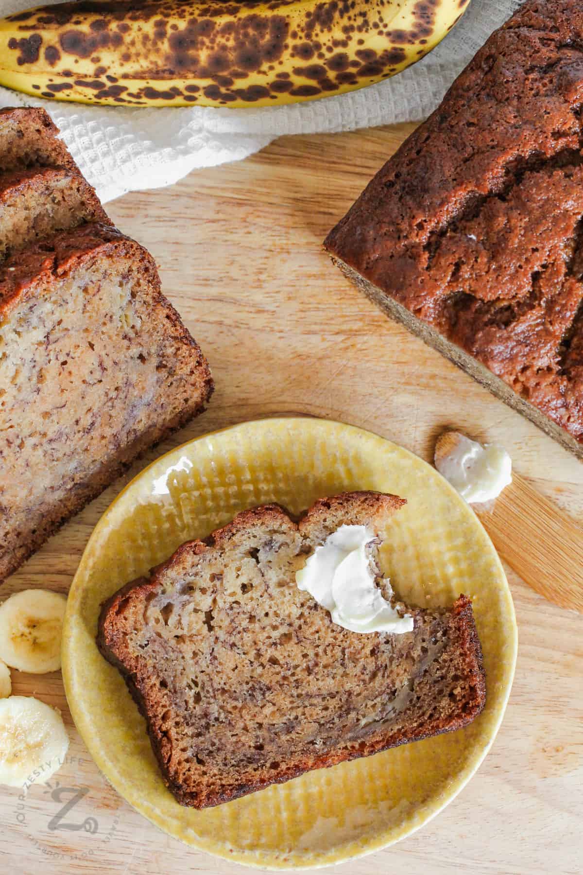 Nut-Free Banana Bread on a yellow plate with loaf beside it