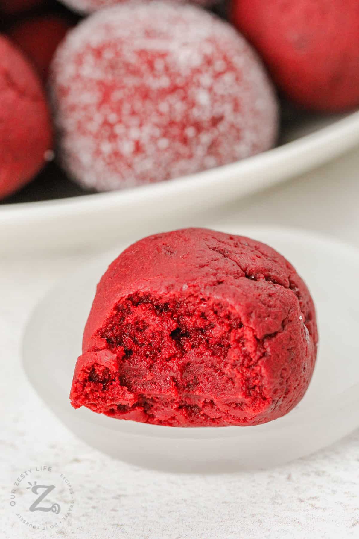 No Bake Red Velvet Cake Balls with one on a plate and a bite taken out