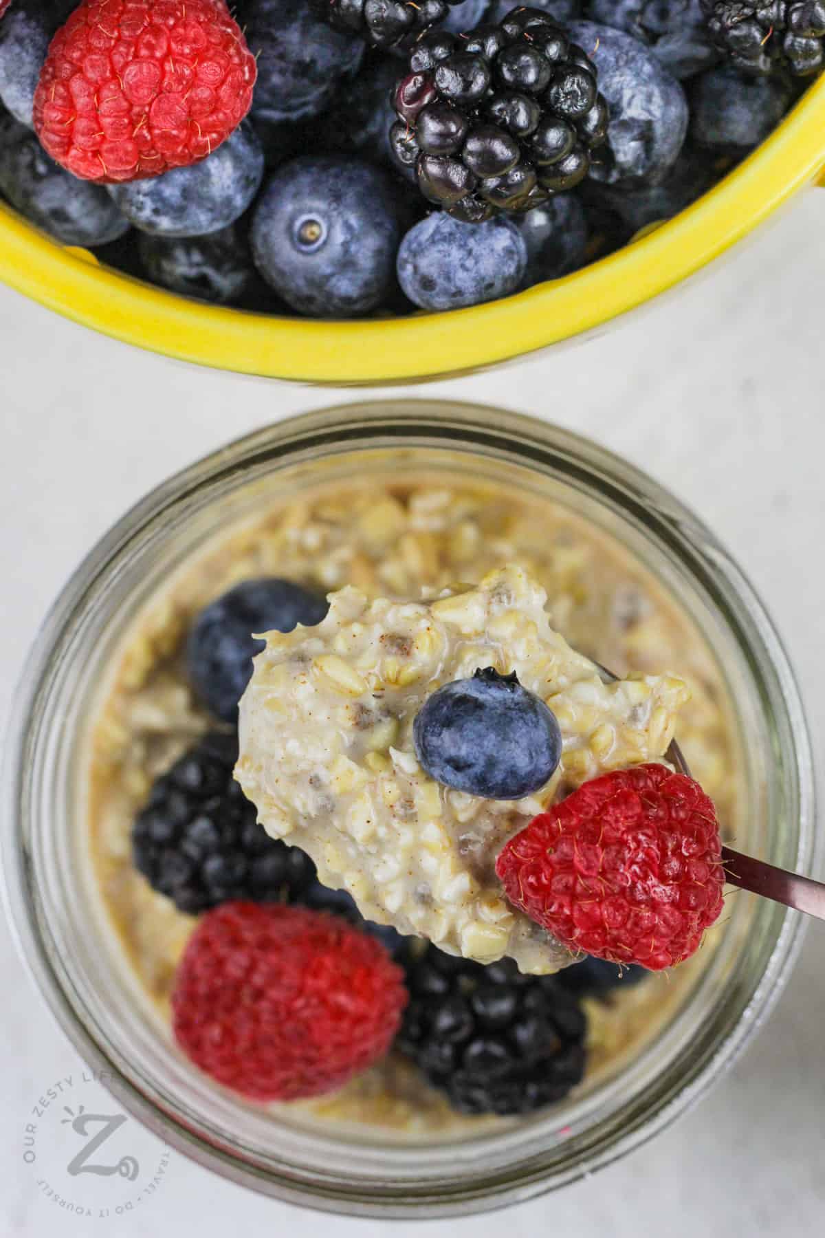 Overnight Steel Cut Oats with berries on a spoon