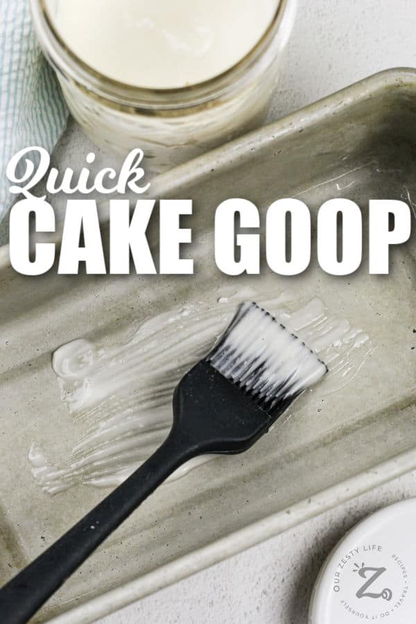 spreading Cake Goop on a pan with writing
