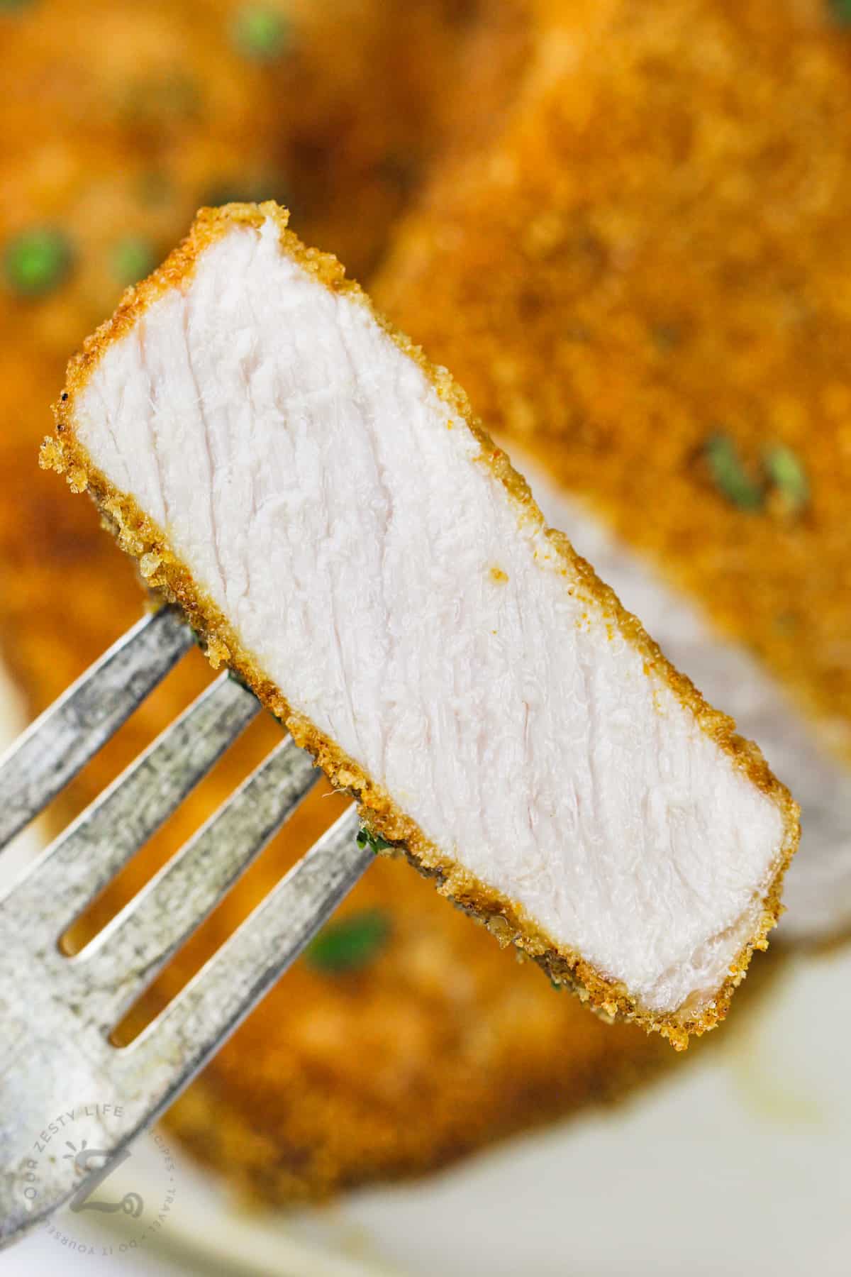 close up of Air Fryer Shake N Bake Pork Chops on a fork