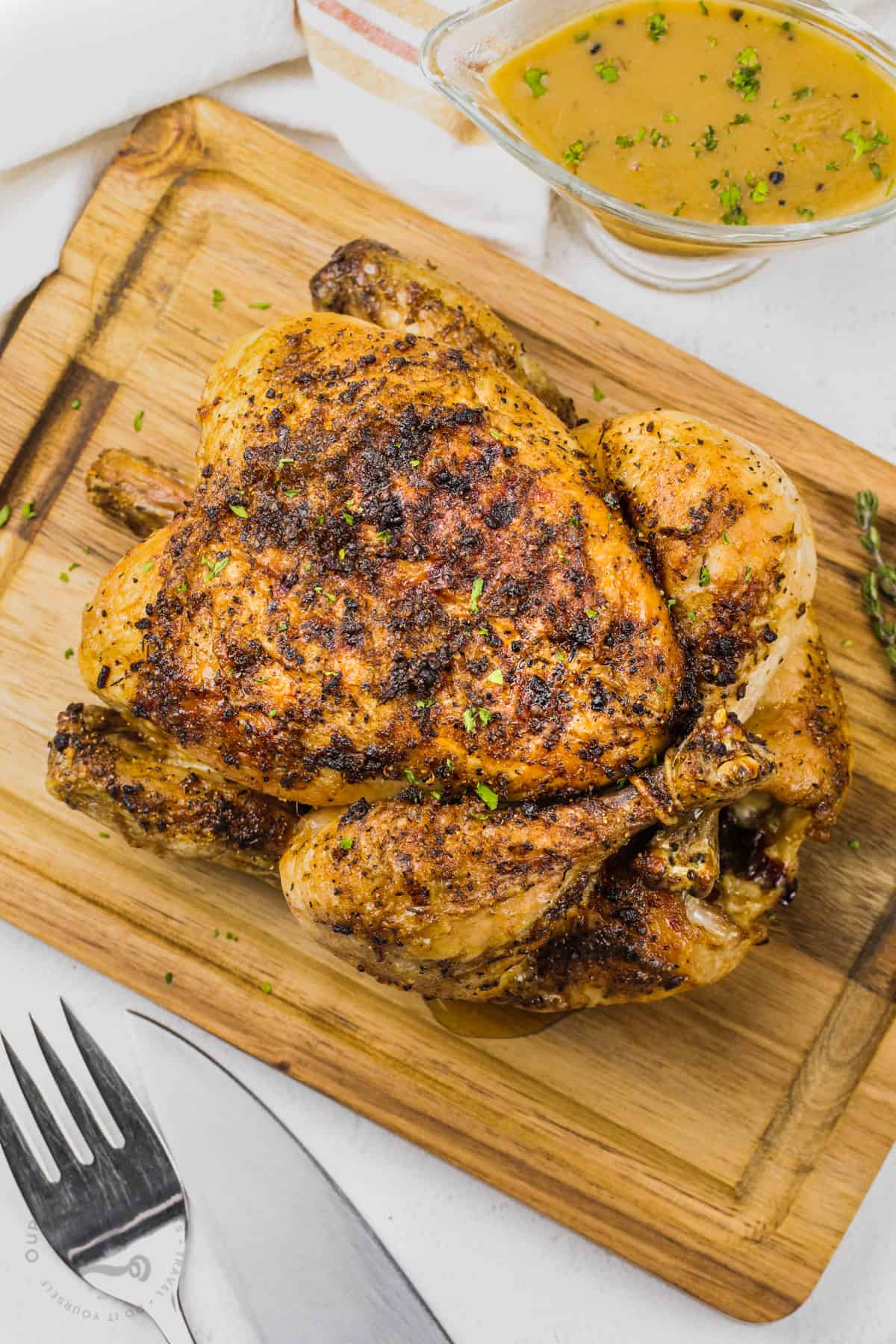 Air Fryer Whole Chicken on a cutting board
