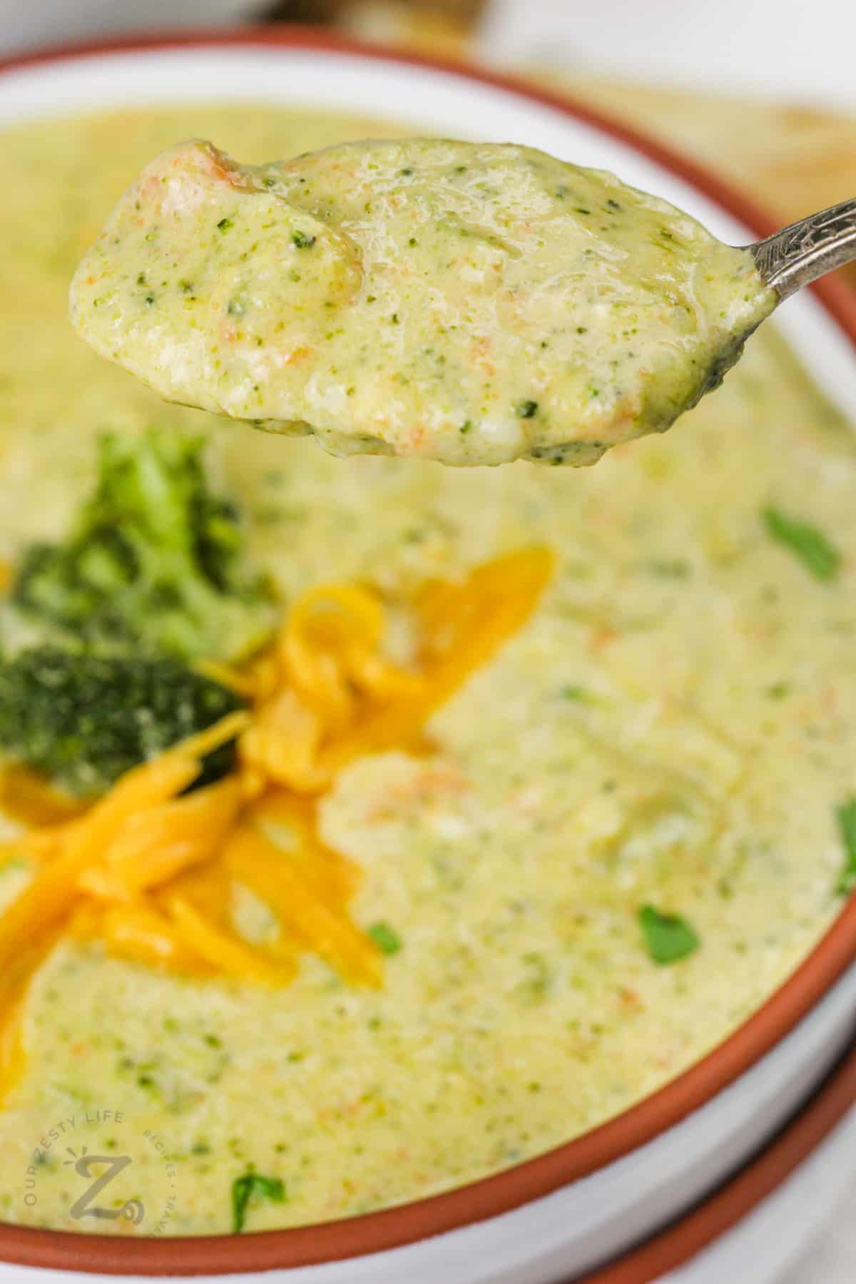bowl of Broccoli Cheese Soup with a spoon full
