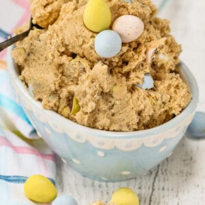 bowl of Easter Edible Cookie Dough with pastel cloth and mini eggs