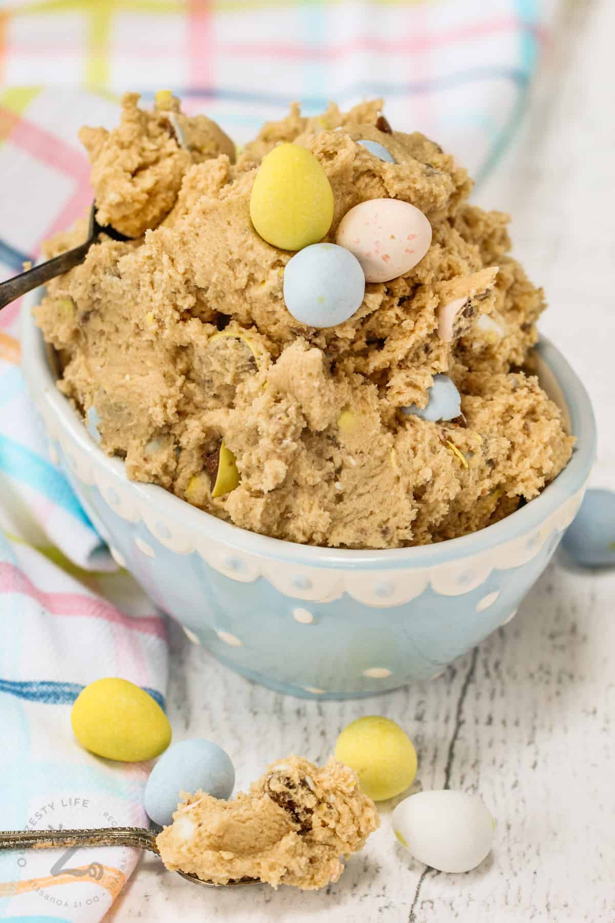 bowl of Easter Edible Cookie Dough with pastel cloth and mini eggs