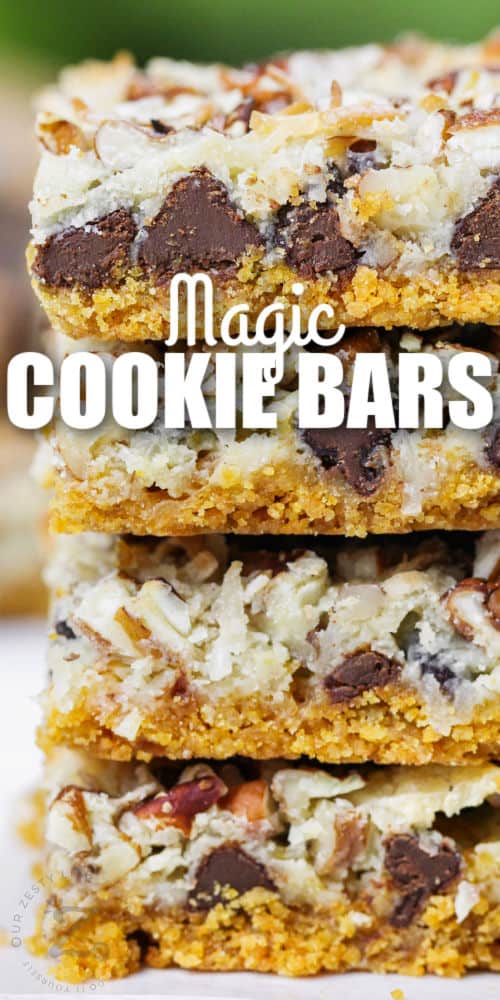 close up of Magic Cookie Bars pieces in a pile with writing