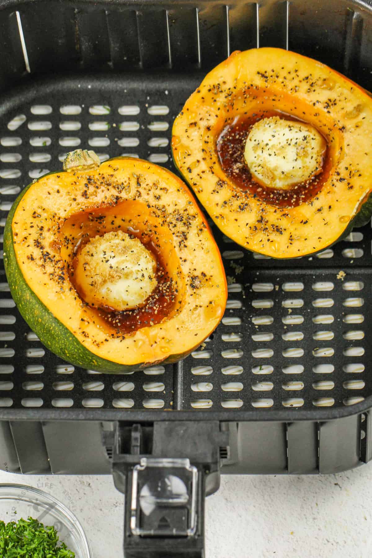 Air Fryer Acorn Squash in the fryer before cooking