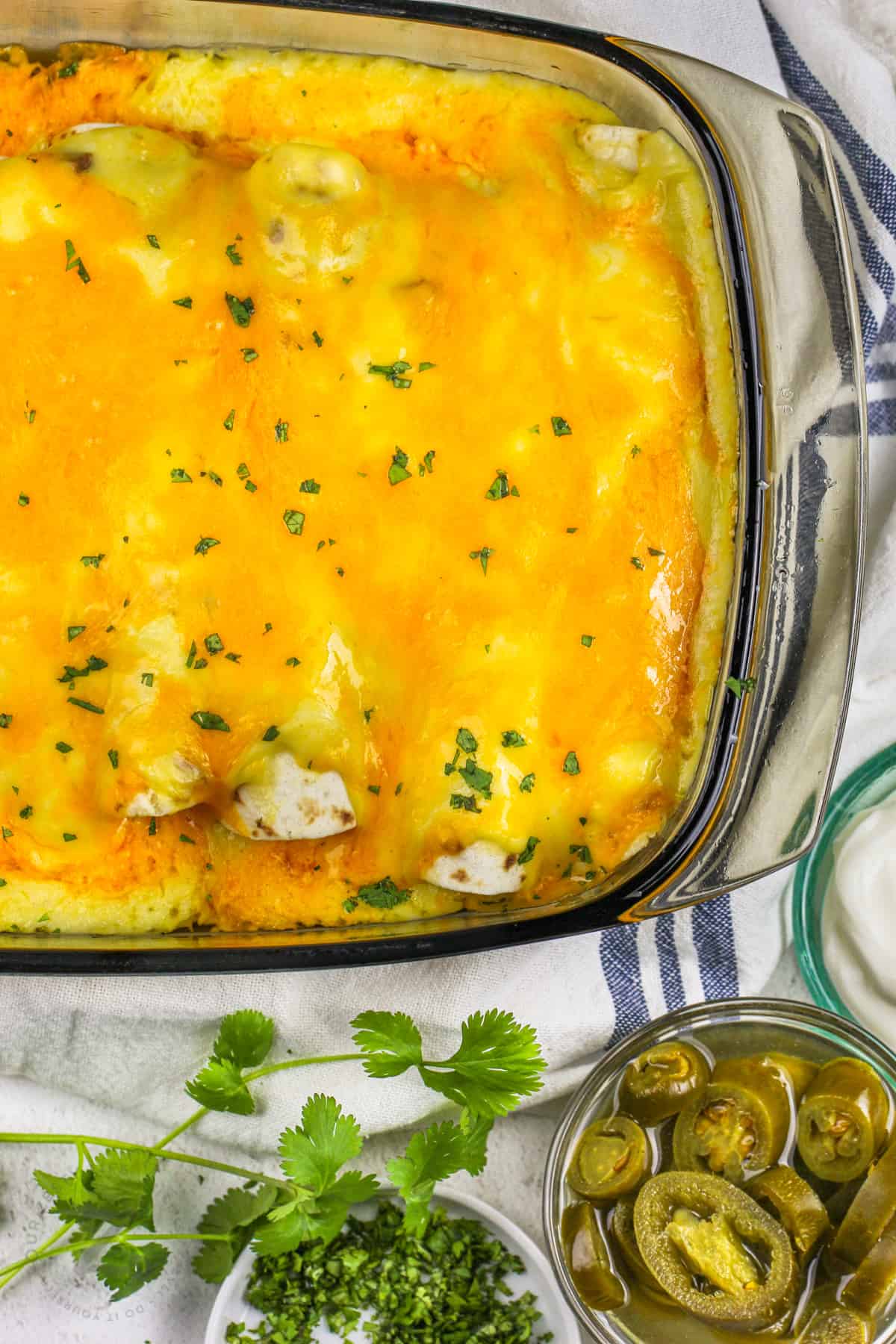 close up of Creamy Chicken Enchiladas cooked in the pan