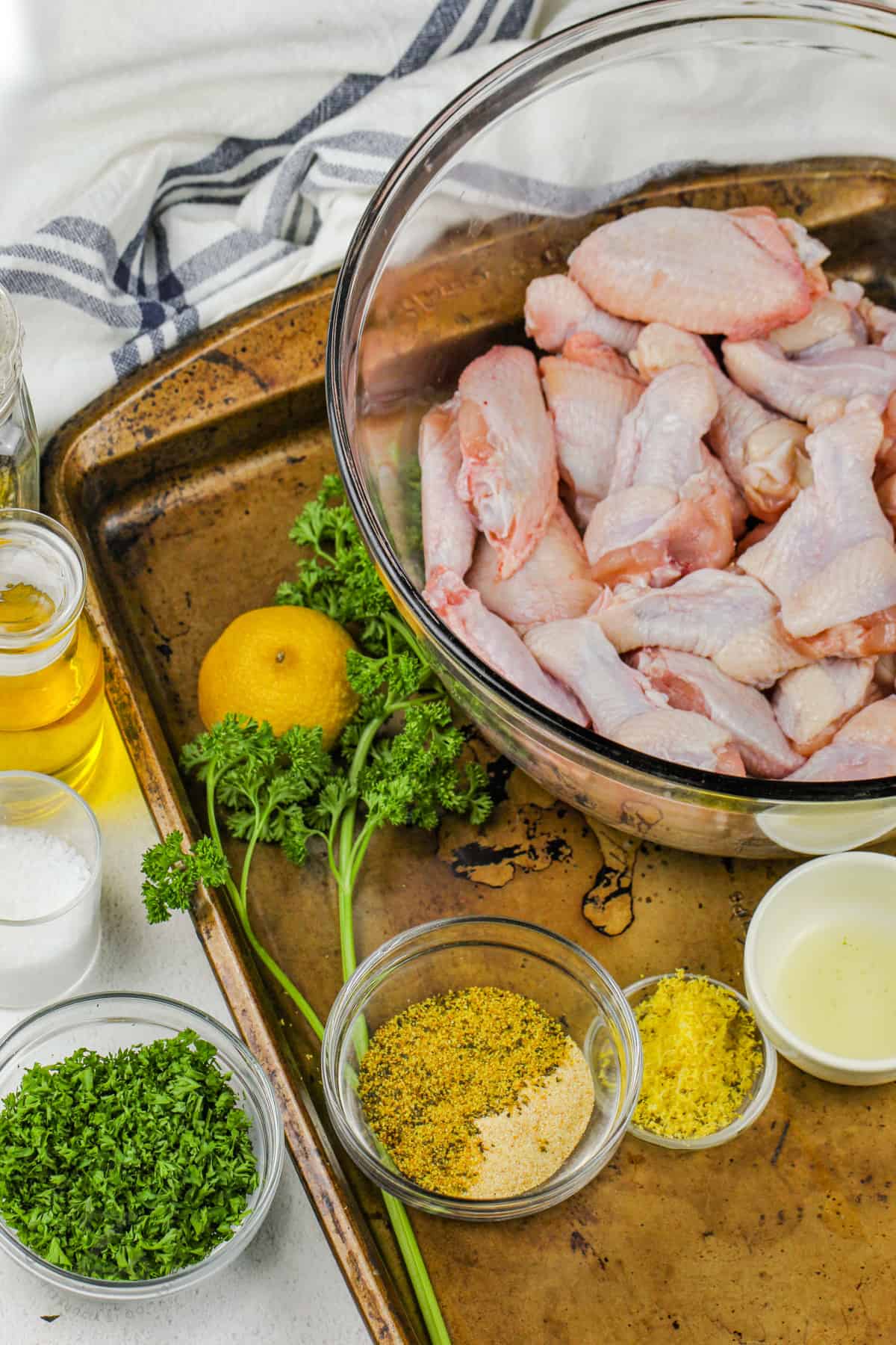 chicken and ingredients in bowls to make Lemon Pepper Chicken Wings