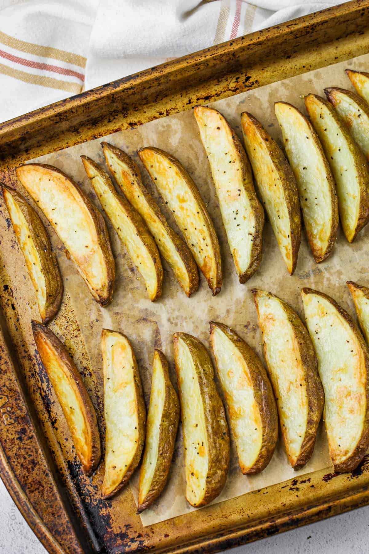 close up of cooked Potato Wedges on a baking sheet
