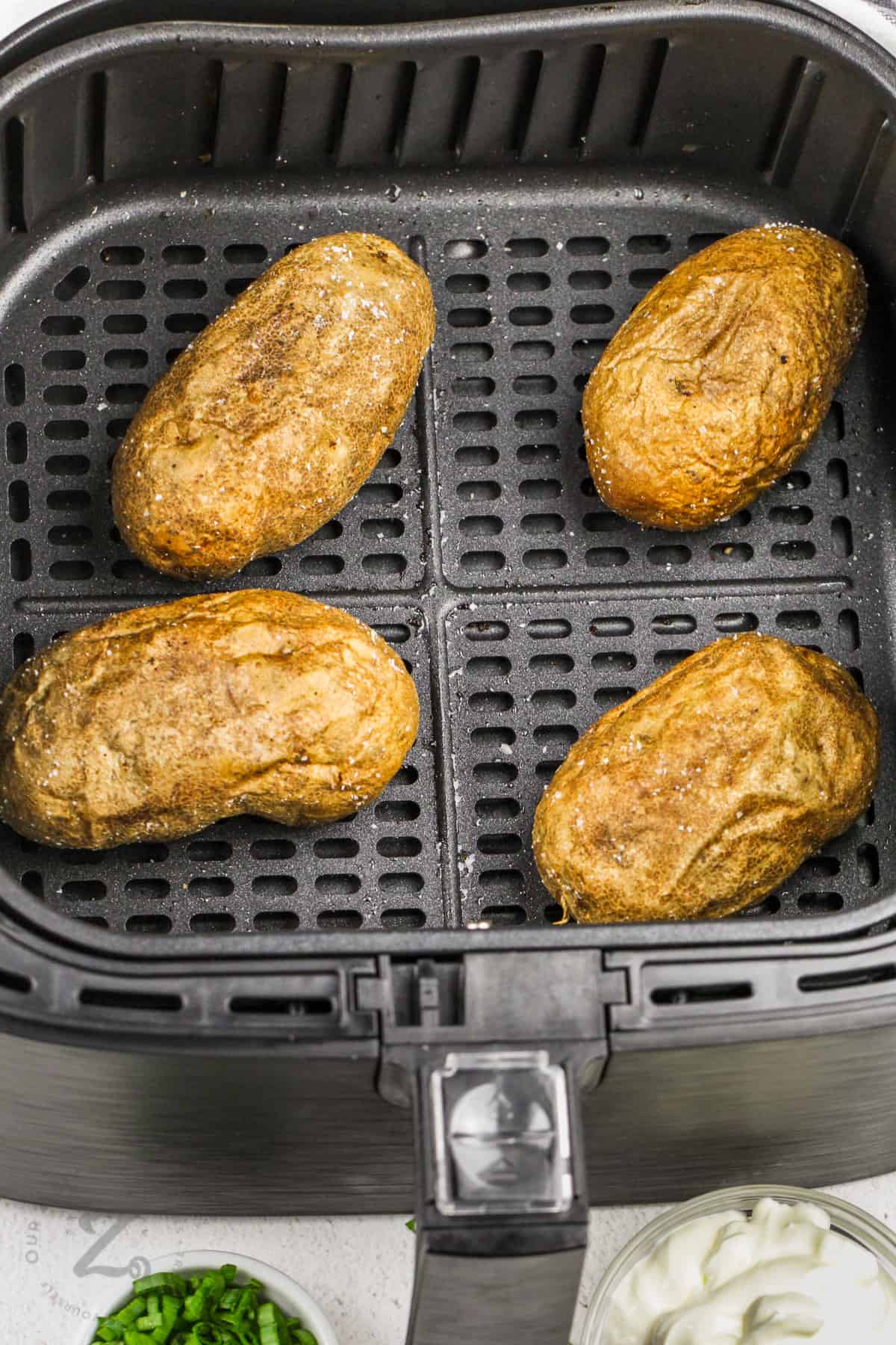 cooked Air Fryer Baked Potatoes in the fryer