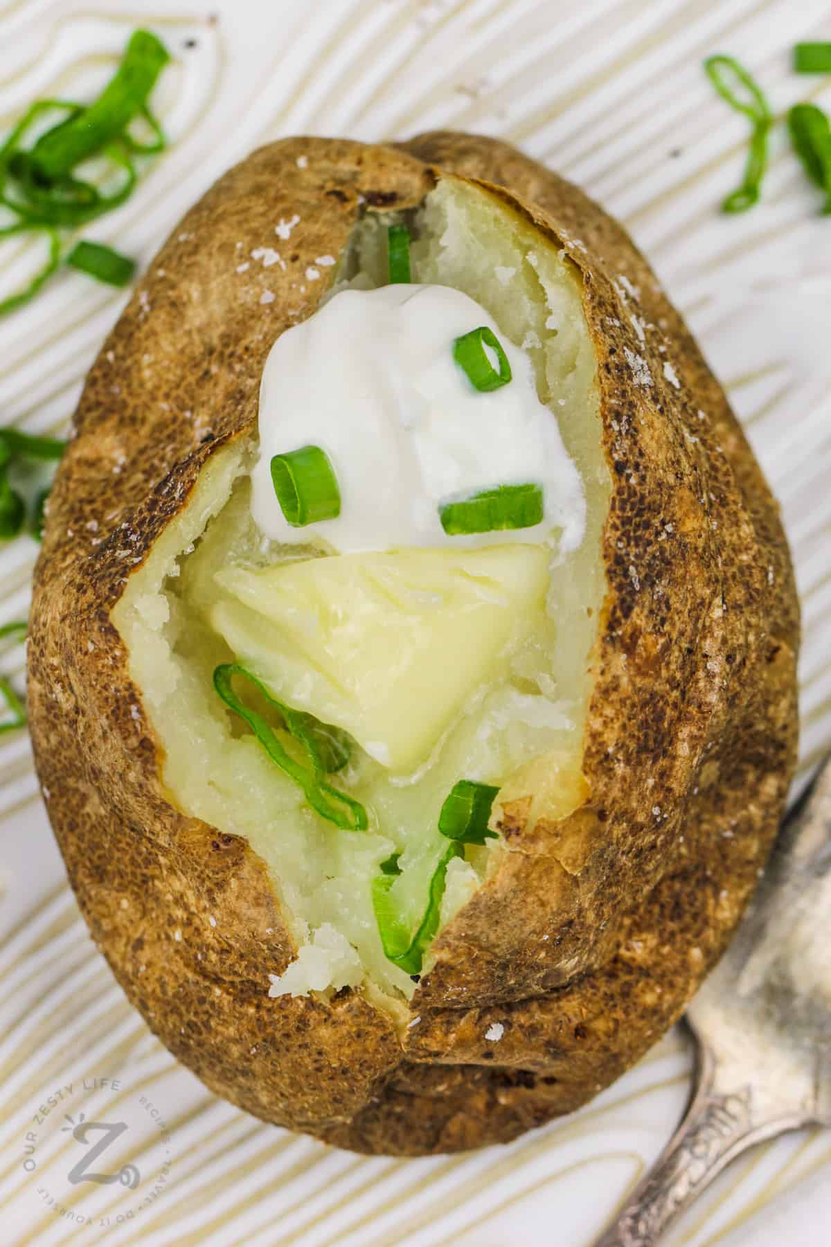 Air Fryer Baked Potatoes with butter and sour cream