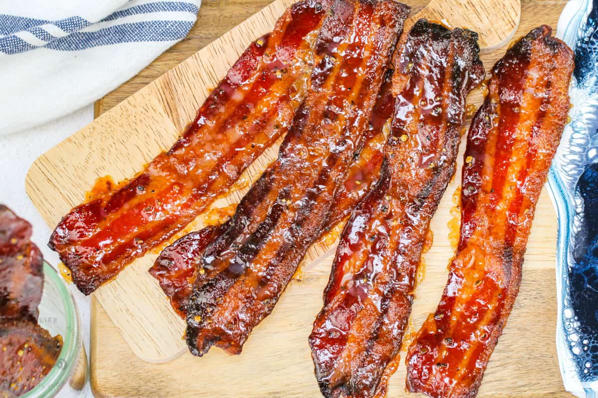 adding sauce to bacon to make Candied Bacon