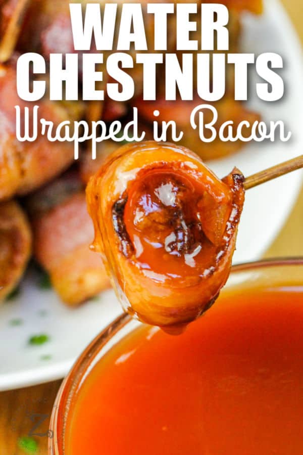 dipping Bacon Wrapped Water Chestnuts in sauce with writing