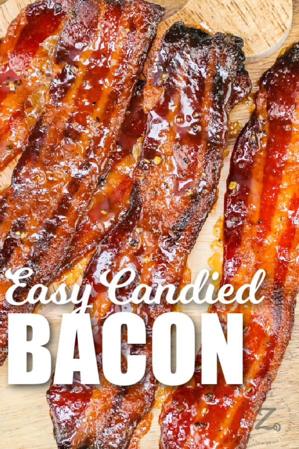 close up of Candied Bacon on a wooden board with writing