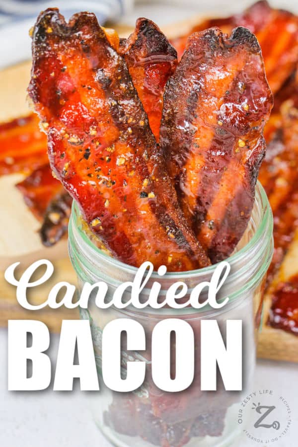 jar of Candied Bacon with bacon in the background with a title