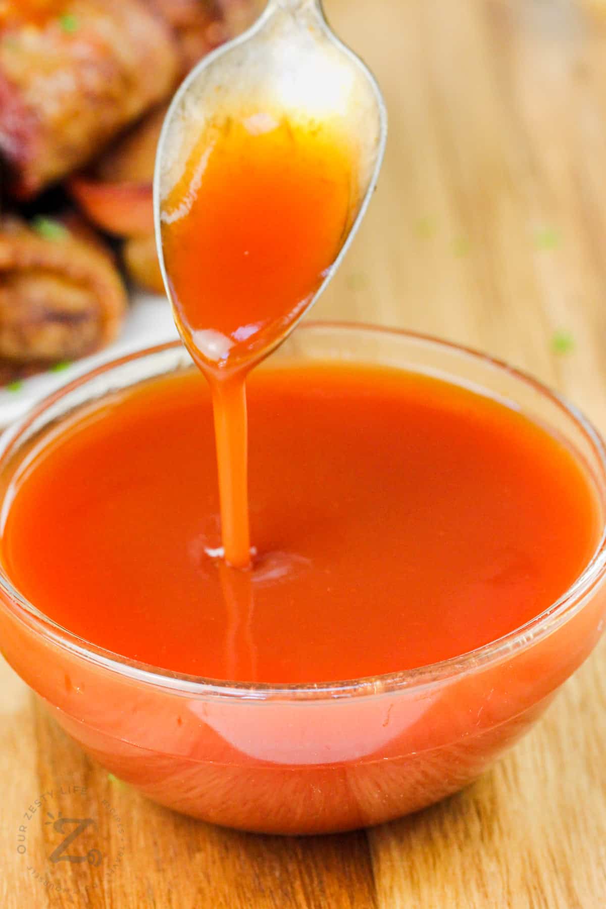 pouring Simple Sweet and Sour Sauce from a spoon to a bowl