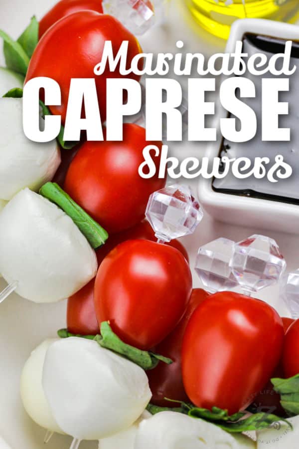 Caprese Skewers on a plate with writing