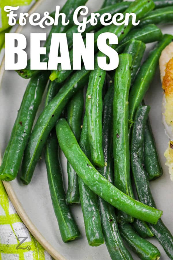cooked Green Beans on a plate with writing