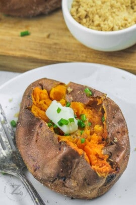 Air Fryer Baked Sweet Potato on a plate with sour cream