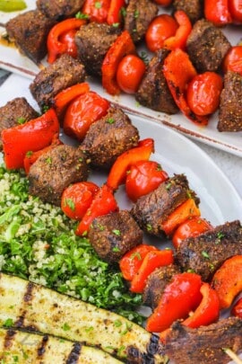 Beef Kabobs on a plate with salad
