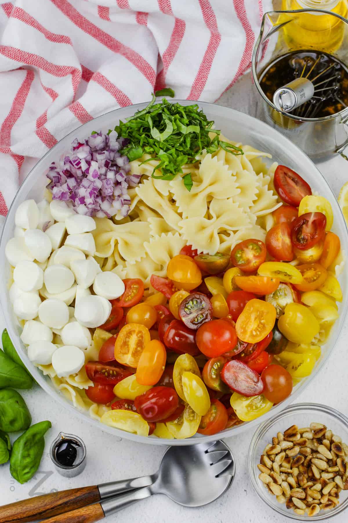 ingredients in a bowl to make Caprese Pasta Salad