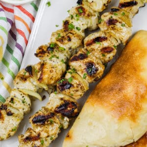 plated Chicken Souvlaki with bread and tzatziki