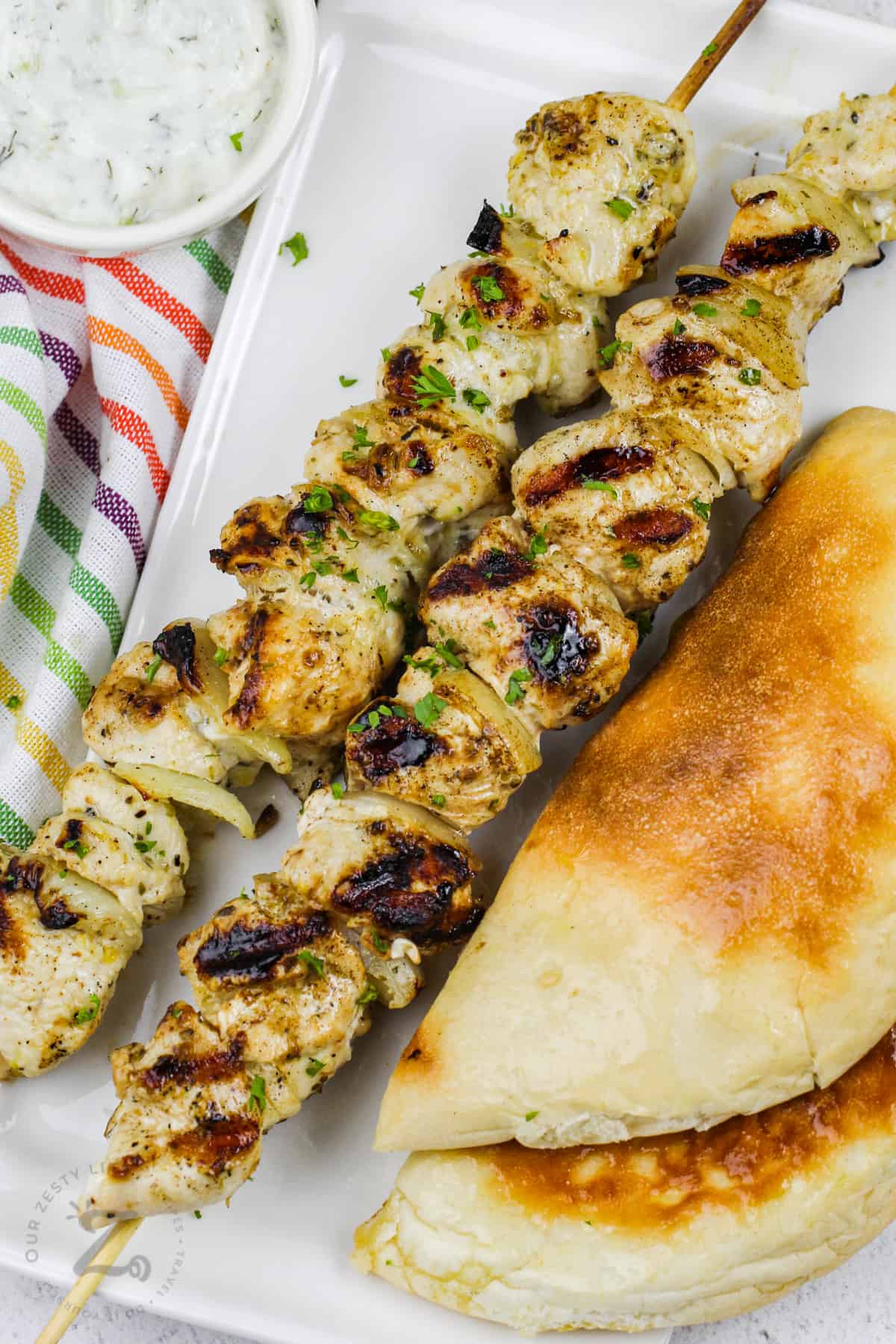 plated Chicken Souvlaki with bread and tzatziki
