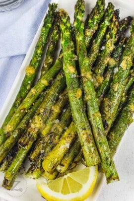 Grilled Asparagus on a plate with a lemon slice