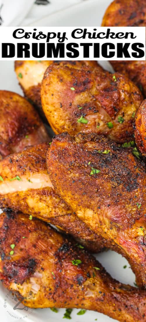 close up of Smoked Chicken Drumsticks on a plate with a title