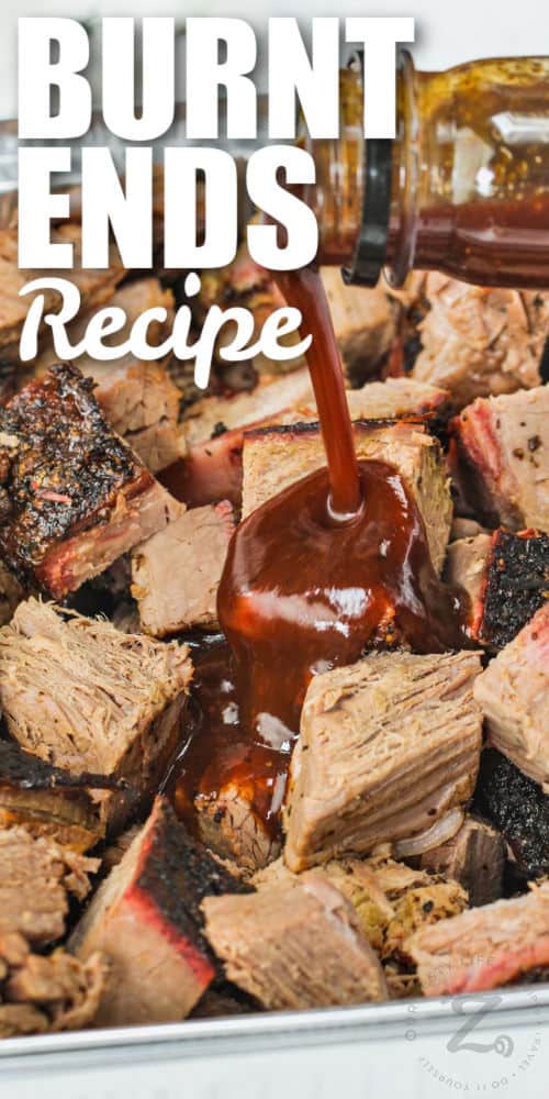 adding sauce to steak to make Burnt Ends with writing