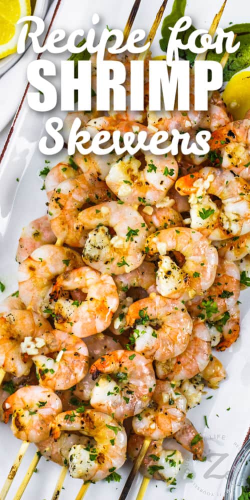 Grilled Shrimp Skewers on a plate with garnish and a title