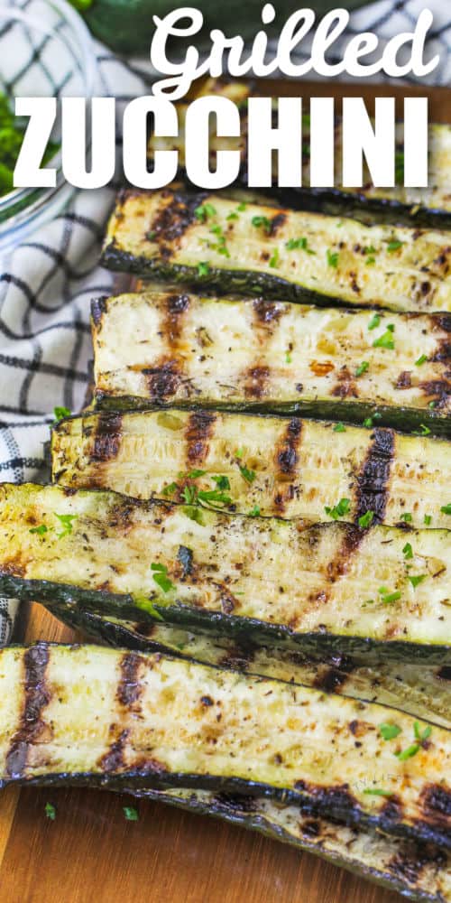 close up of Grilled Zucchini on a board with a title