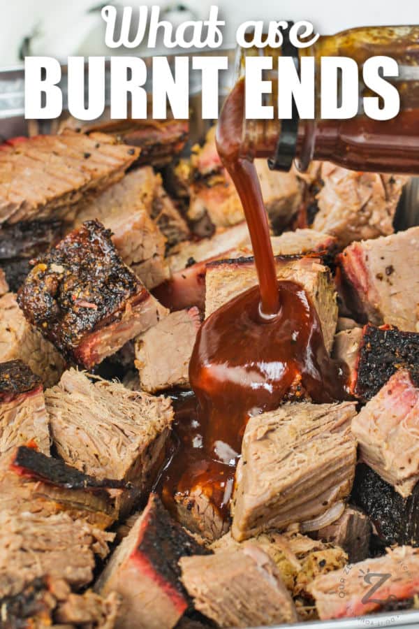 adding sauce to steak bites to make Burnt Ends with a title
