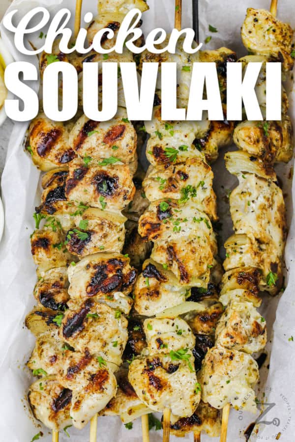cooked Chicken Souvlaki on a plate with writing