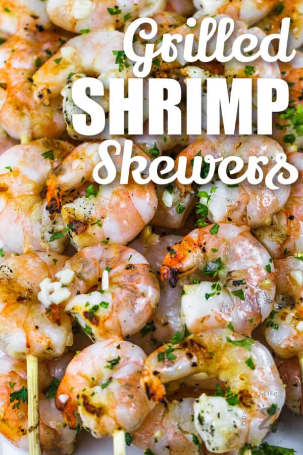 Grilled Shrimp Skewers on a plate with writing