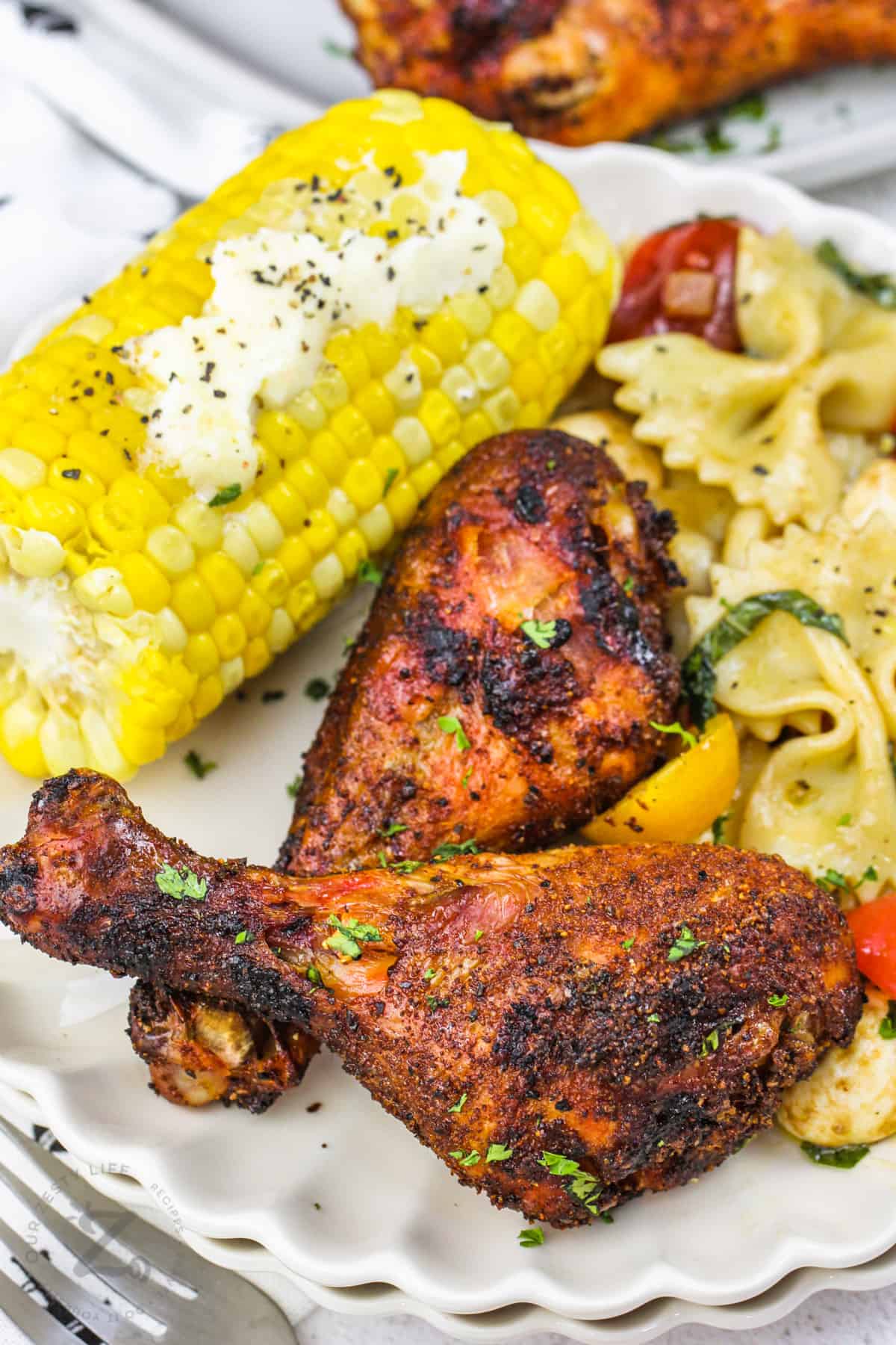 Smoked Chicken Drumsticks with pasta salad and corn