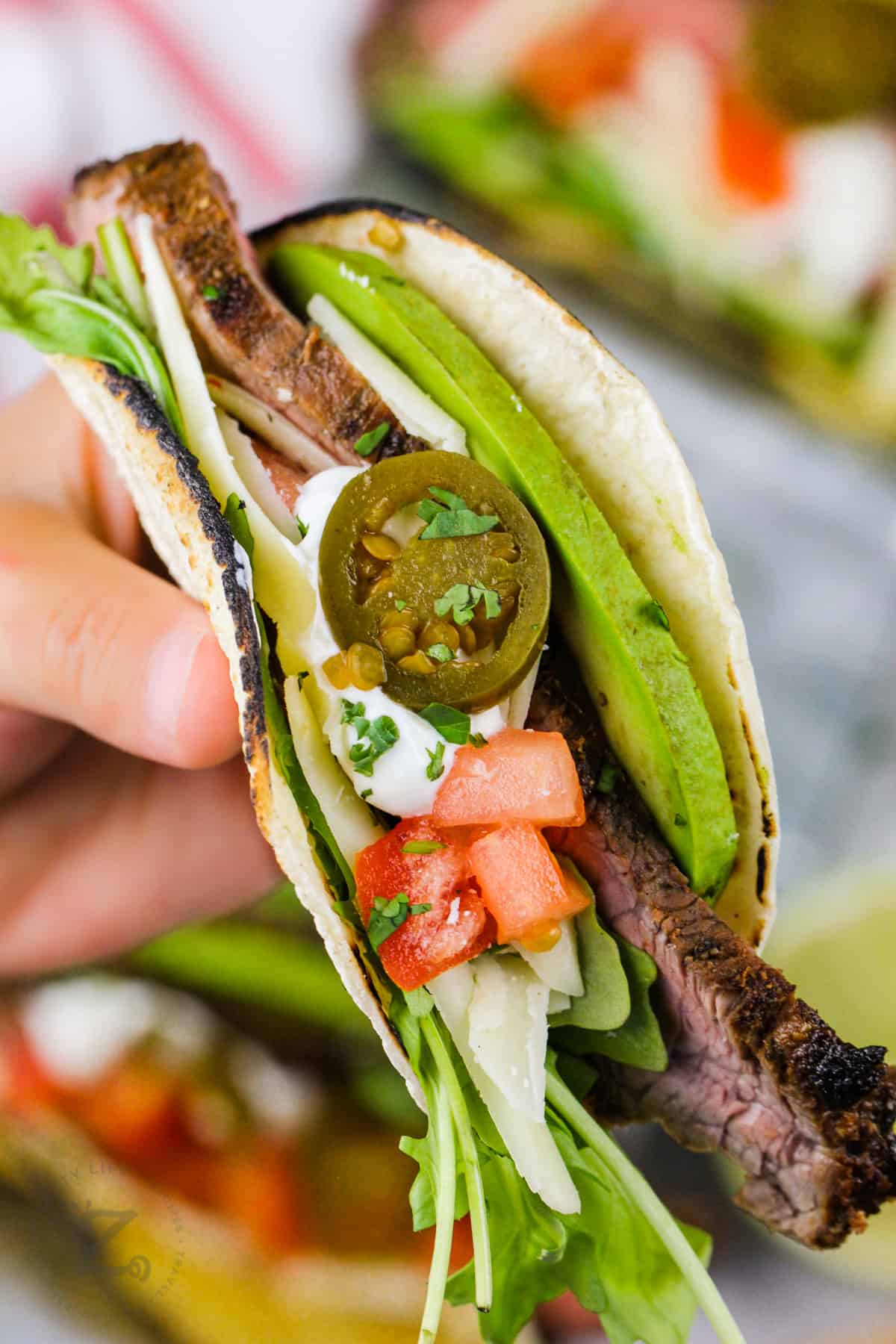 close up of Flank Steak Tacos with toppings