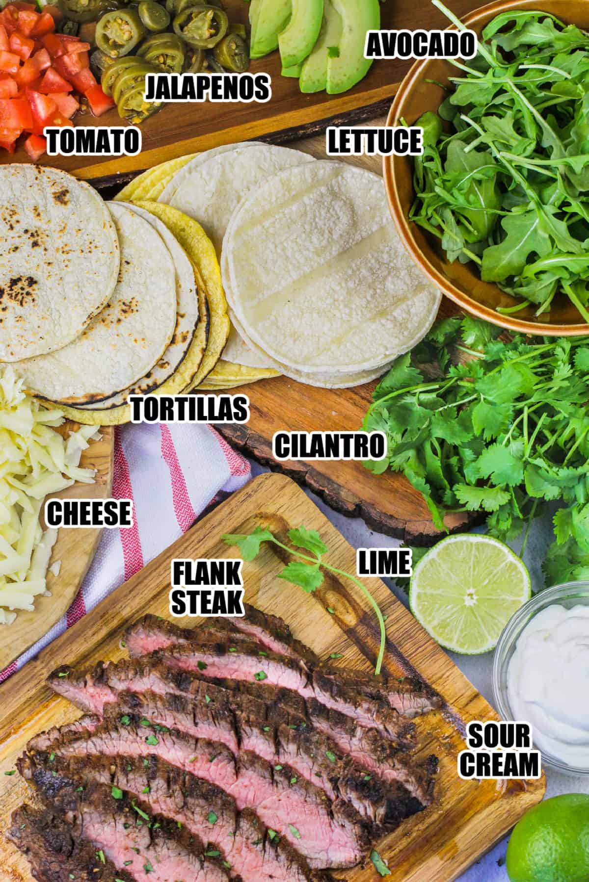 flank steak , tortillas , cheese , sour cream and toppings to make Flank Steak Tacos