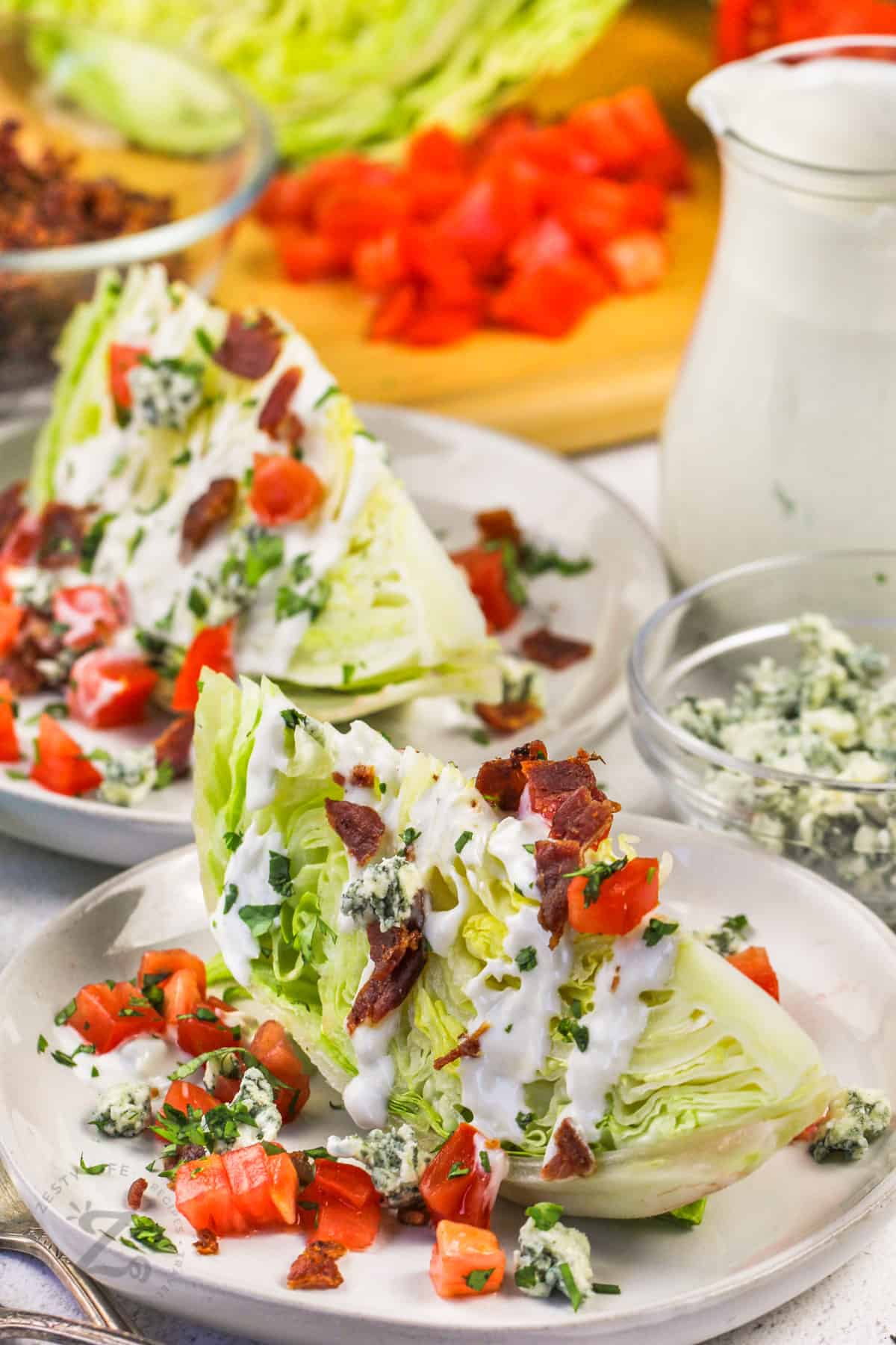 plates with Wedge Salad and ingredients in the back