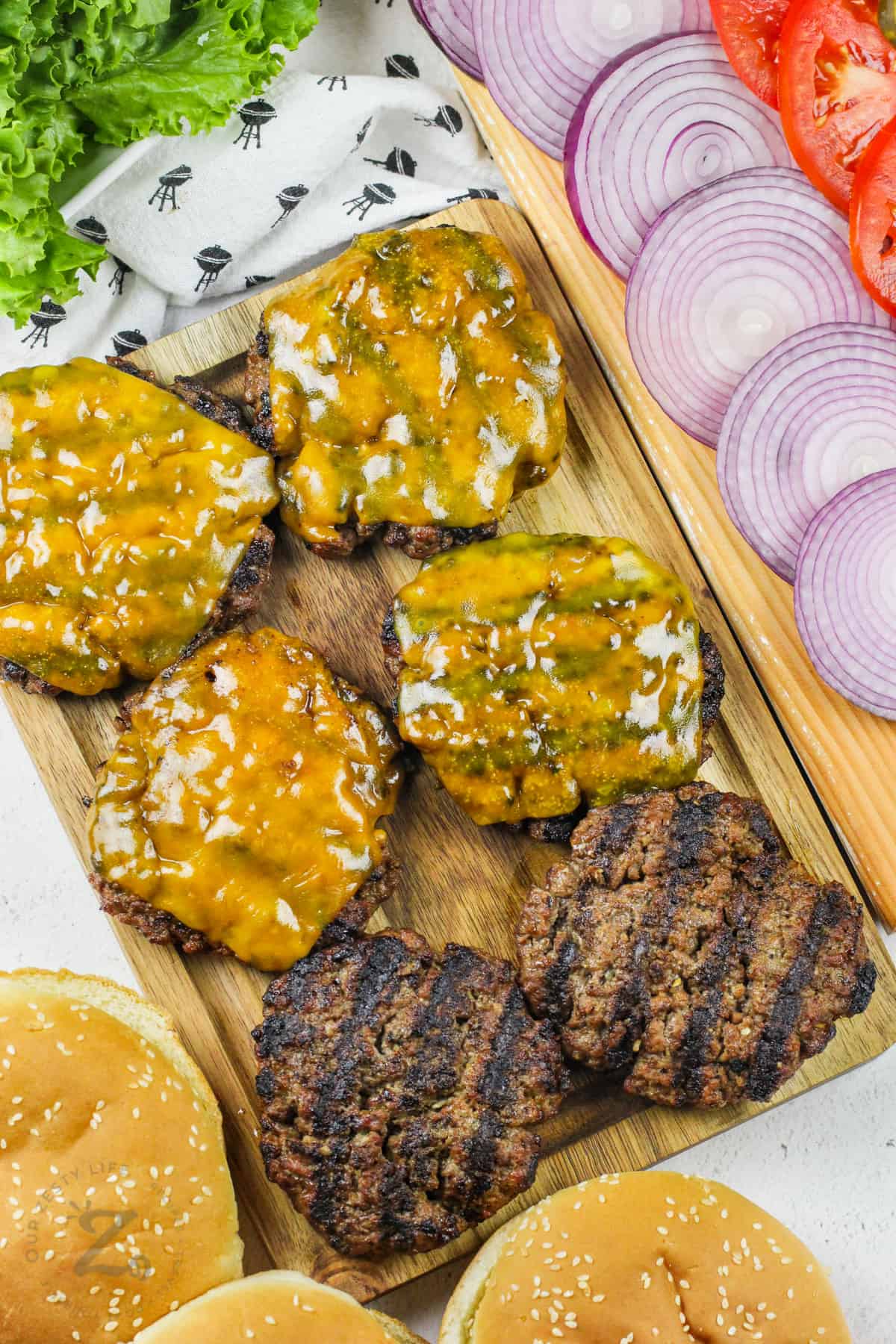 cooked Hamburger Patties with dressing around it