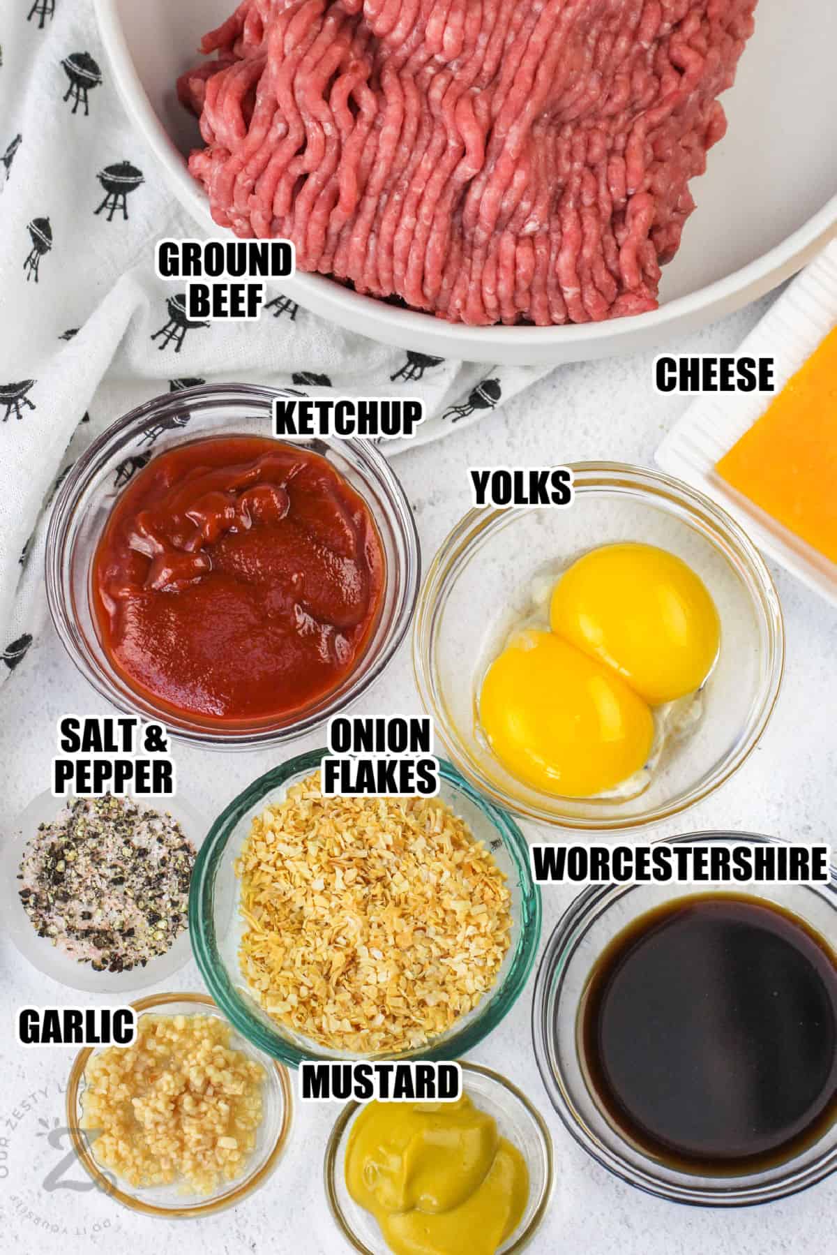 beef , ketchup, mustard, cheese , onion flakes and other ingredients in bowls to make Hamburger Patties with labels