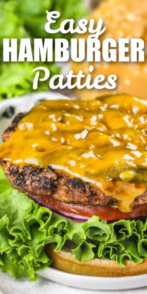 cooked Hamburger Patties on a bun with cheese and writing