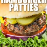 close up of Hamburger Patties on a bun with writing