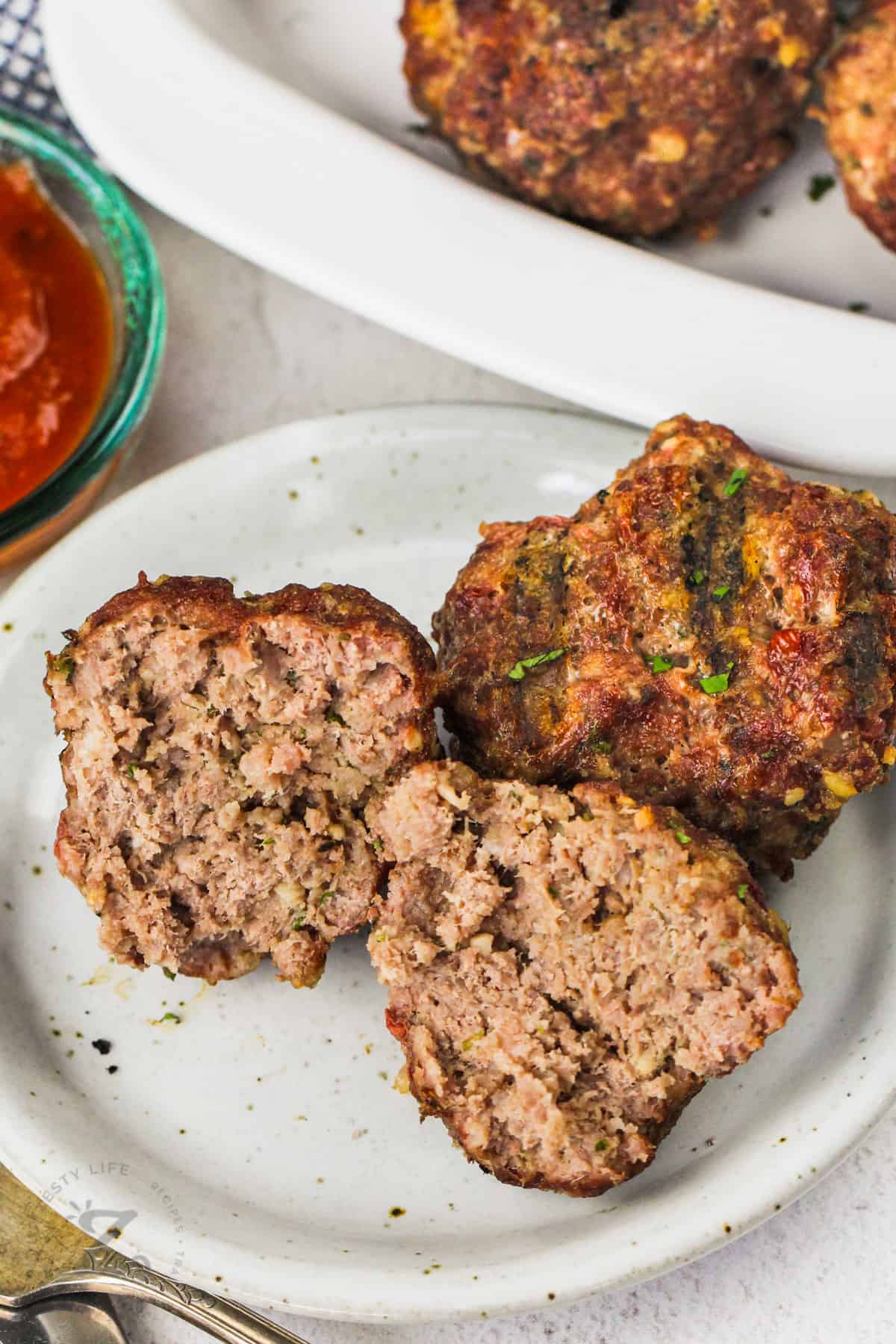plated Smoked Meatballs with one in half to show middle